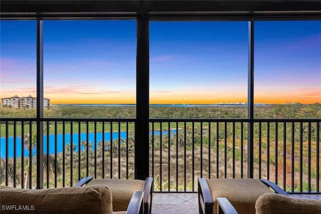sunroom / solarium with a water view