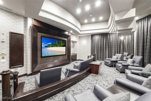 home theater room with wallpapered walls, baseboards, and lofted ceiling