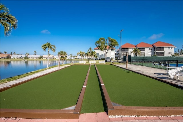 view of community featuring a bocce ball area, a residential view, and a water view