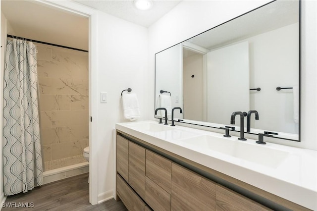 1428 Park Shore Cir Unit 2, Fort Myers, FL 33901 - bathroom featuring toilet, wood finished floors, a shower stall, and double vanity