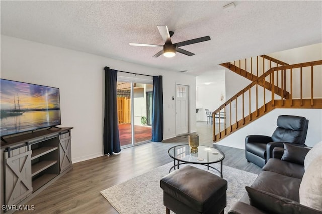 1428 Park Shore Cir Unit 2, Fort Myers, FL 33901 - living area with wood finished floors, stairs, a textured ceiling, a ceiling fan, and baseboards