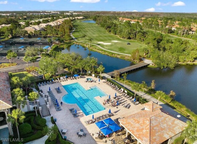 20290 Burnside Pl Unit 1102, Estero, FL 33928 - drone / aerial view of a pool, a nearby body of water, and a golf course