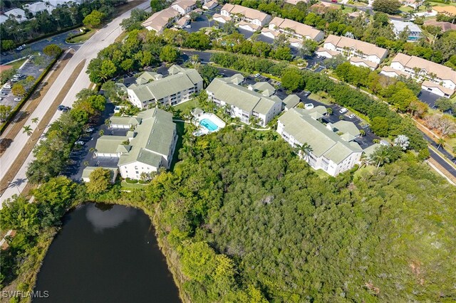 aerial view of property's location with nearby suburban area and a large body of water