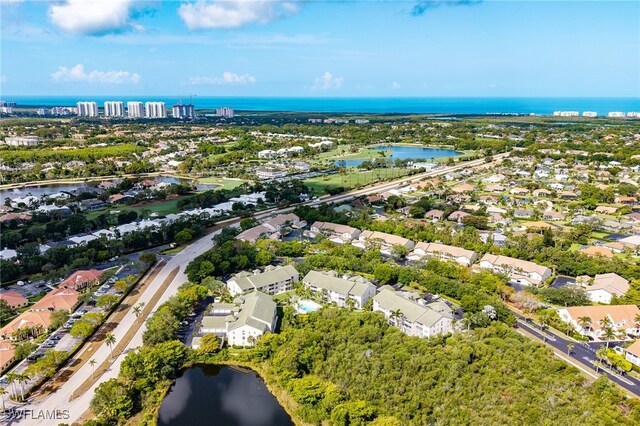 aerial view of property's location featuring a nearby body of water and nearby suburban area