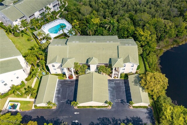 bird's eye view of a pool area and a nearby body of water