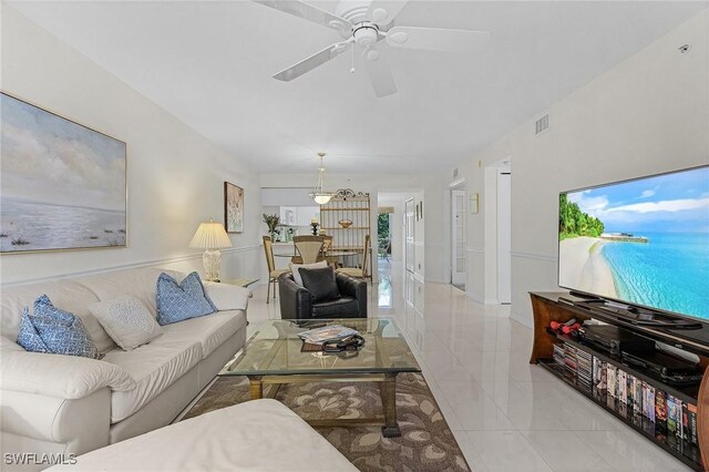 living room with ceiling fan and tile patterned flooring