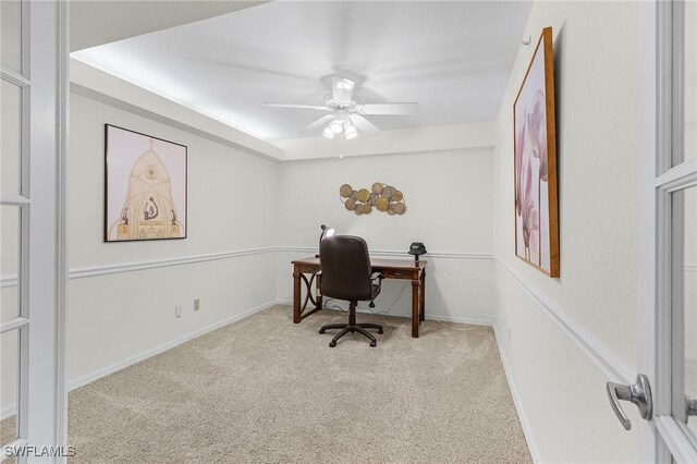 office area featuring carpet floors, a ceiling fan, and baseboards