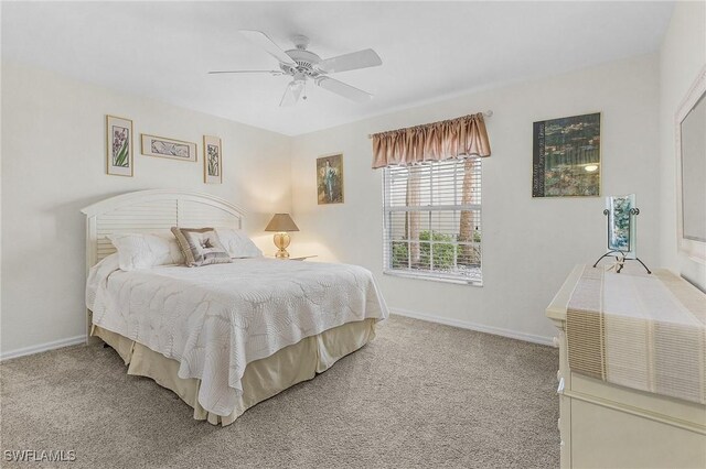 carpeted bedroom with baseboards and a ceiling fan