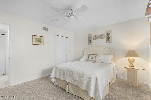 bedroom featuring carpet floors, a closet, baseboards, and a ceiling fan