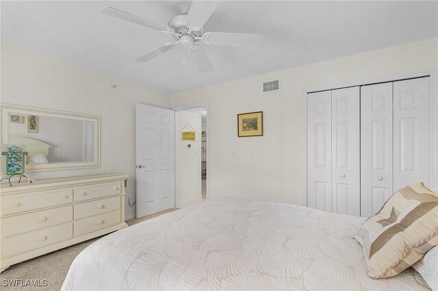 carpeted bedroom featuring a closet and a ceiling fan
