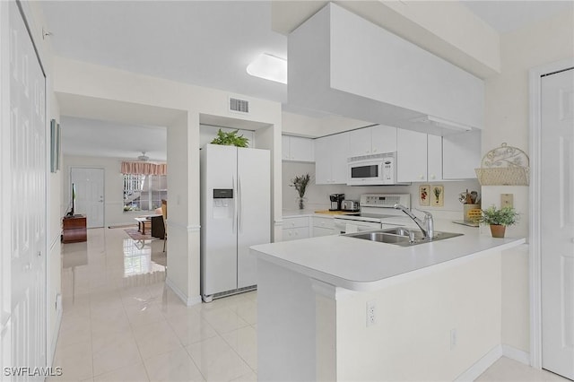 28881 Bermuda Lago Ct Unit 102, Bonita Springs, FL 34134 - kitchen featuring white appliances, a peninsula, light countertops, white cabinetry, and light tile patterned floors