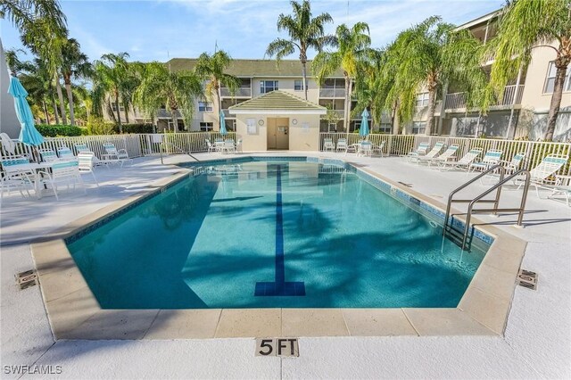 community pool featuring fence and a patio area