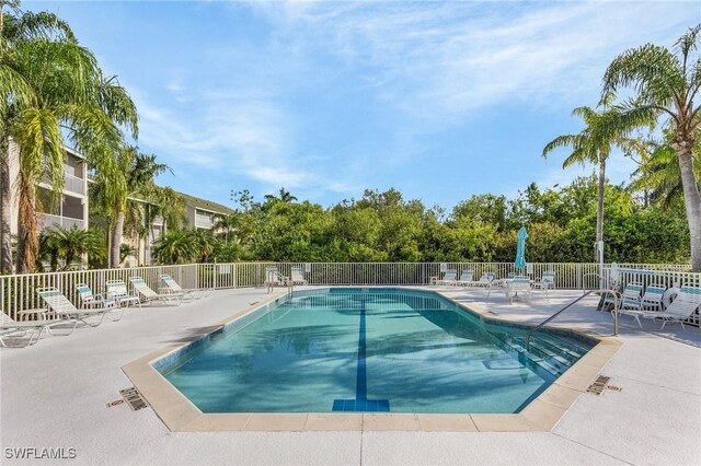 community pool featuring fence and a patio area