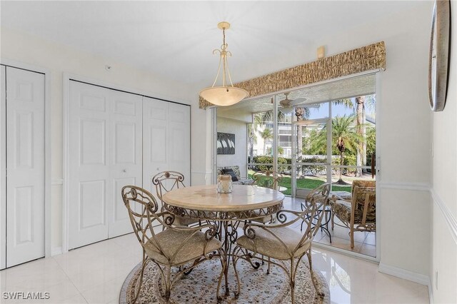 dining area featuring baseboards and light tile patterned floors