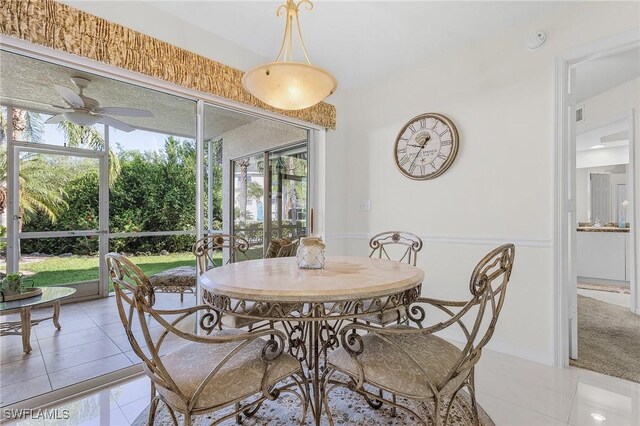 dining area with light tile patterned floors, plenty of natural light, and ceiling fan