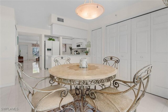 dining area with light tile patterned floors