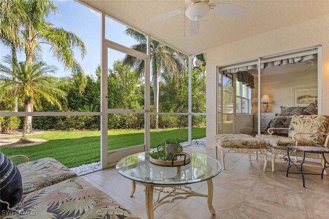 sunroom / solarium with a ceiling fan and vaulted ceiling