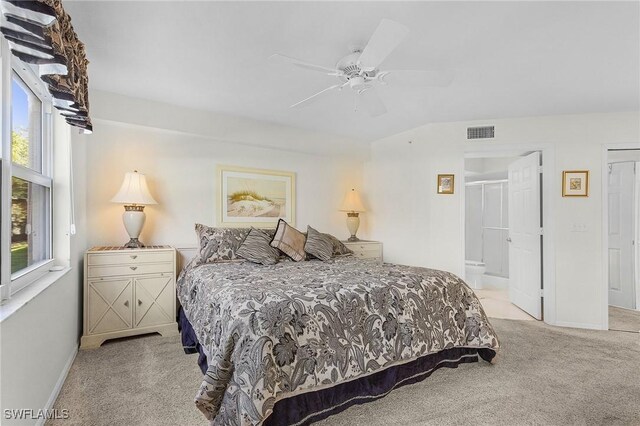 bedroom with light carpet, baseboards, a ceiling fan, and ensuite bathroom