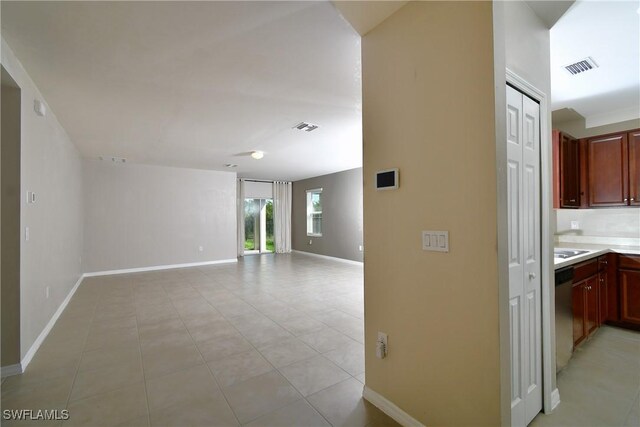 hall with baseboards and light tile patterned flooring
