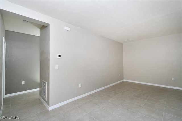 spare room featuring baseboards