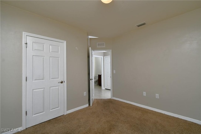 unfurnished bedroom featuring carpet flooring and baseboards