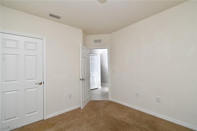 unfurnished bedroom featuring carpet floors and baseboards