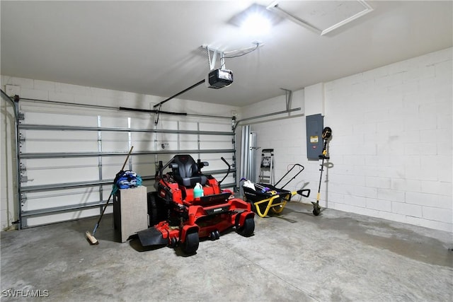 garage with a garage door opener, electric panel, and concrete block wall
