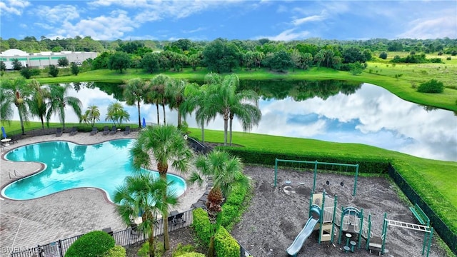 community pool featuring a water view and fence