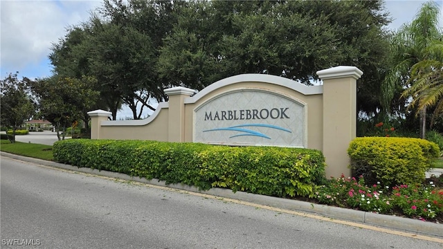 community sign featuring an attached garage