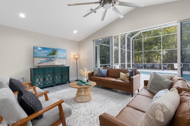 living area with lofted ceiling, wood finished floors, ceiling fan, recessed lighting, and baseboards