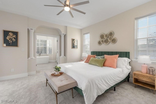 bedroom featuring ornate columns, multiple windows, light carpet, and a ceiling fan