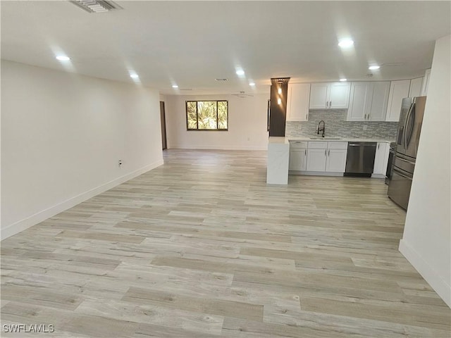 524 Marlin Dr, Punta Gorda, FL 33950 - kitchen featuring appliances with stainless steel finishes, open floor plan, a sink, light countertops, and white cabinetry
