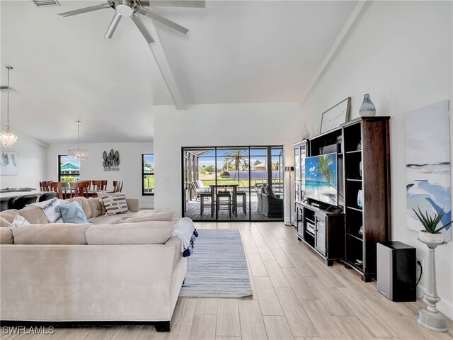 living room featuring ceiling fan, a chandelier, and light wood-style flooring