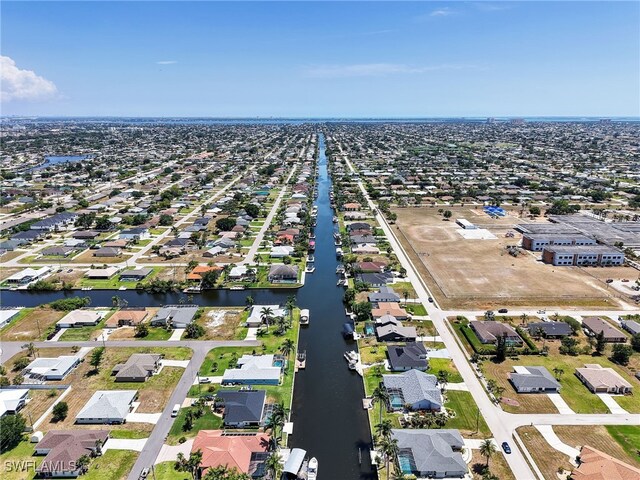 aerial view of residential area featuring a large body of water