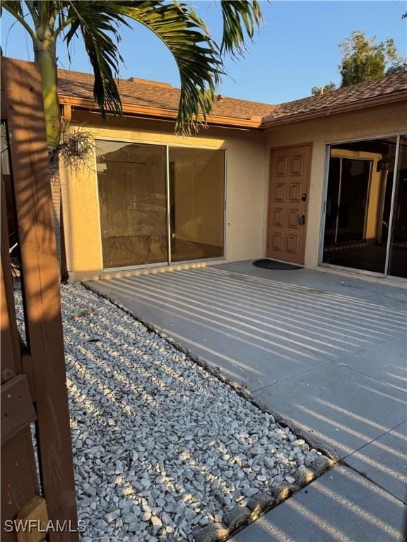 6321 Royal Woods Dr, Fort Myers, FL 33908 - entrance to property featuring stucco siding and a patio