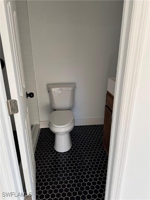 6321 Royal Woods Dr, Fort Myers, FL 33908 - bathroom featuring baseboards, toilet, tile patterned flooring, and vanity