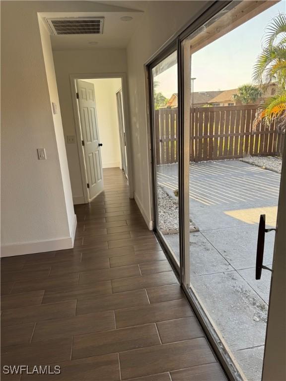 6321 Royal Woods Dr, Fort Myers, FL 33908 - corridor with baseboards and dark wood-style flooring