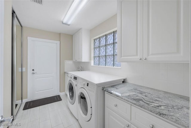 3613 Exuma Way, Naples, FL 34119 - washroom with cabinet space, separate washer and dryer, and baseboards