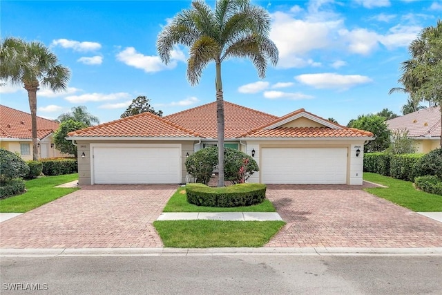 3613 Exuma Way, Naples, FL 34119 - mediterranean / spanish house with stucco siding, a tile roof, and decorative driveway
