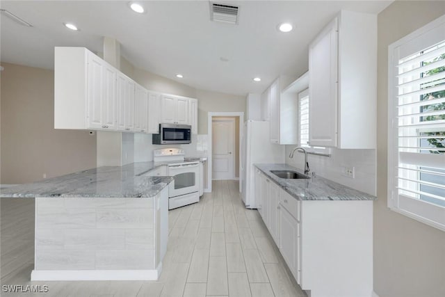 3613 Exuma Way, Naples, FL 34119 - kitchen featuring white electric stove, stainless steel microwave, a sink, plenty of natural light, and recessed lighting