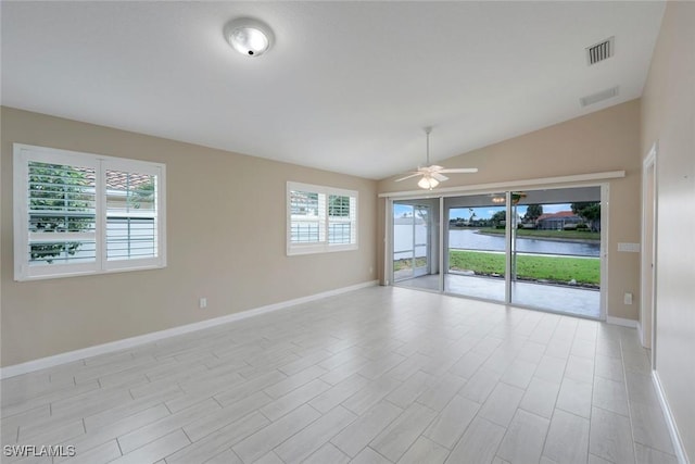 3613 Exuma Way, Naples, FL 34119 - spare room featuring a water view, healthy amount of natural light, lofted ceiling, baseboards, and ceiling fan