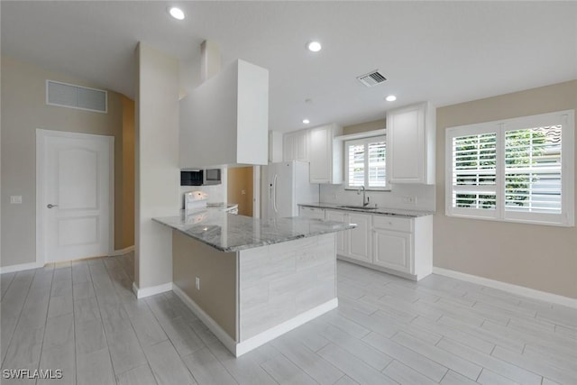 3613 Exuma Way, Naples, FL 34119 - kitchen with white appliances, a sink, wood finish floors, light stone counters, and recessed lighting