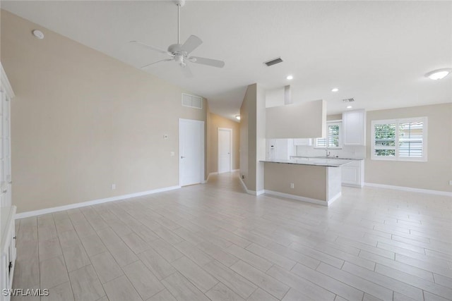 3613 Exuma Way, Naples, FL 34119 - unfurnished living room featuring a ceiling fan, lofted ceiling, light wood-type flooring, baseboards, and recessed lighting