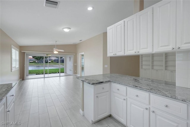 3613 Exuma Way, Naples, FL 34119 - kitchen featuring ceiling fan, lofted ceiling, white cabinets, open floor plan, and light stone counters