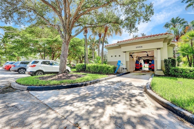 3613 Exuma Way, Naples, FL 34119 - view of front facade featuring stucco siding, concrete driveway, and a tiled roof