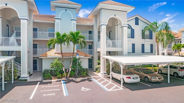 view of property with covered and uncovered parking