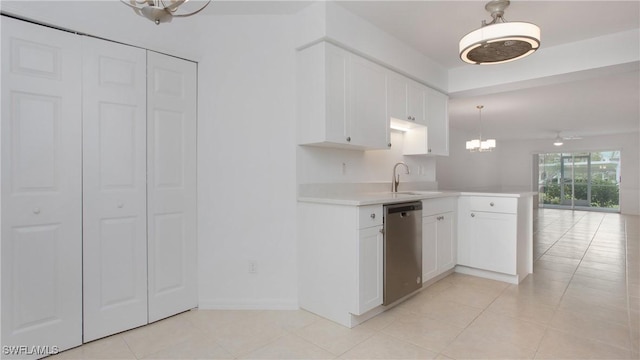 kitchen with a chandelier, dishwasher, a sink, light countertops, and light tile patterned floors