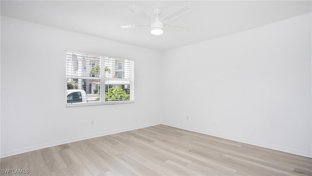 unfurnished room featuring light wood finished floors, ceiling fan, and baseboards