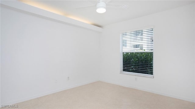 unfurnished room featuring ceiling fan and baseboards