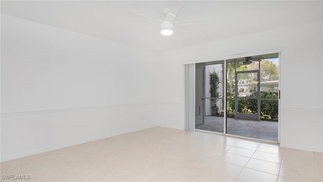 unfurnished room with ceiling fan and light tile patterned flooring